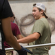 Kyle Rittenhouse helps clean the exterior of Reuther Central High School in Kenosha, Wis., on Tuesday, Aug. 25, 2020. Rittenhouse, 17, was arrested Wednesday, Aug. 26, after two people were shot to death during protests in Kenosha over the police shooting of Jacob Blake.